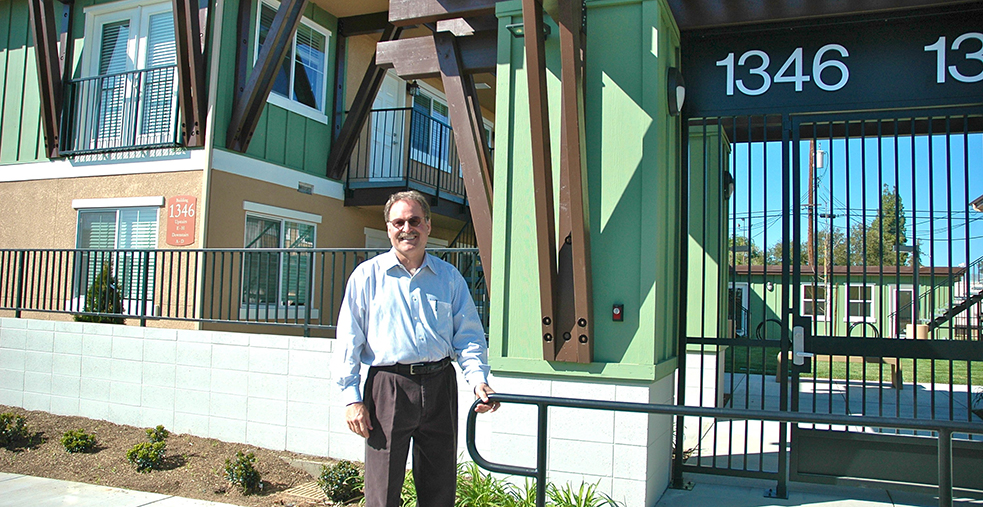 Kurt Zumwalt standing in front of an apartment building