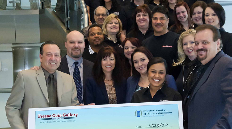 Group of people from the Fresno Coin Gallery with both former superintendent Jim Yovino and current superintendent Michele Copher