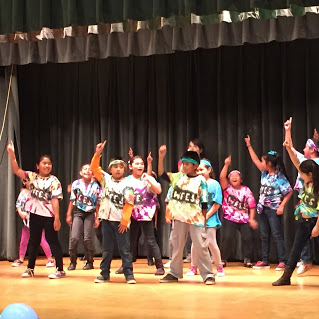 students on stage performing dance